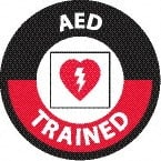 NMC - AED Trained, Hard Hat Label - Round, White & Red on Black, 0.004" Thick, Indoor or Outdoor, Adhesive Backed, For Accident Prevention - Exact Tooling